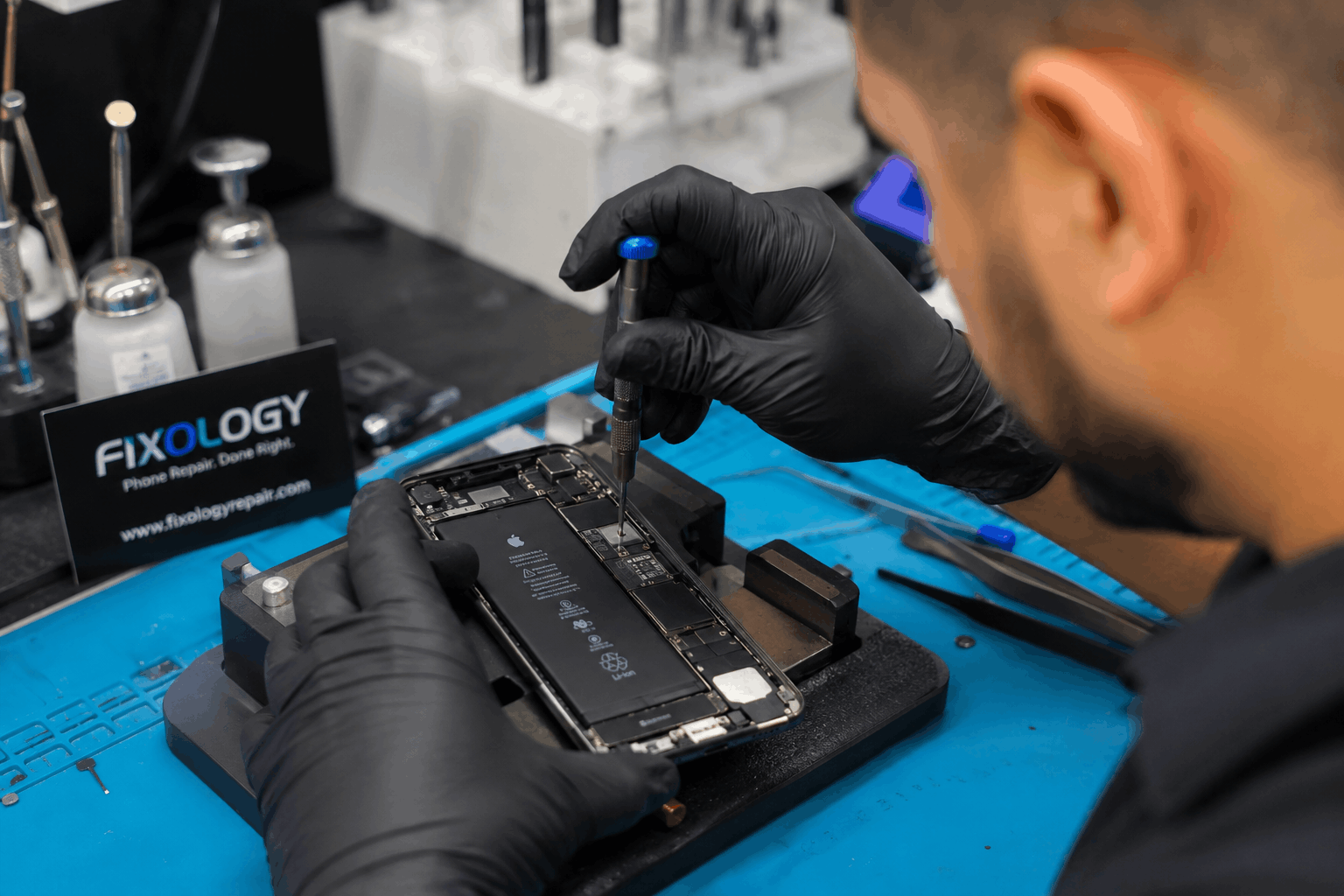 iPhone overheating repair in Houston TX technician fixing damaged motherboard ()
