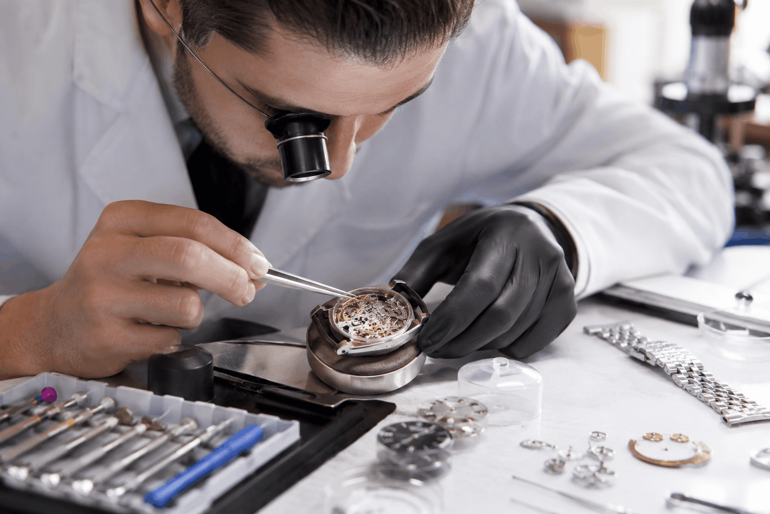 Watch overhaul Bloomington MN technician inspecting mechanical watch movementHD ()